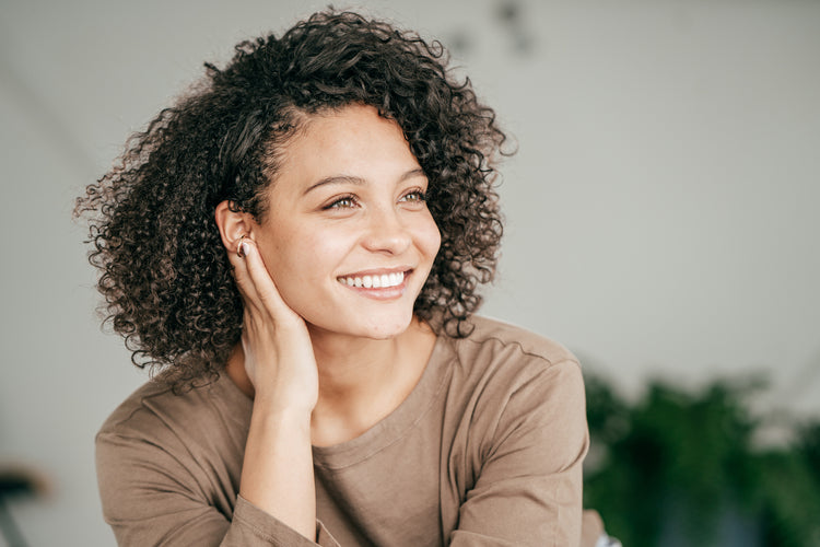 Woman smiling after using alpha arbutin