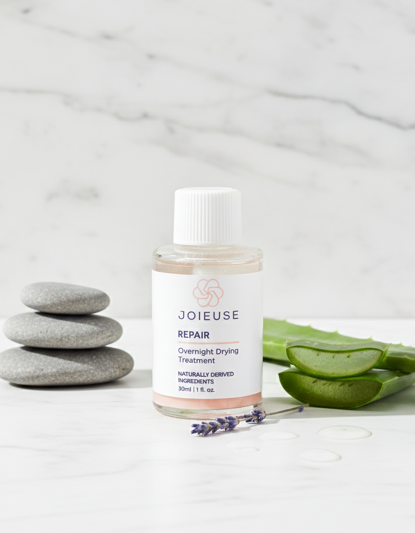 Joieuse skincare bottle with aloe vera and stones on a marble background